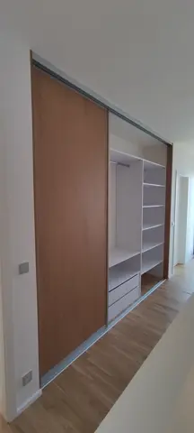 Vstavaná skriňa na mieru do chodby a predsiene s dverami v dekore dub